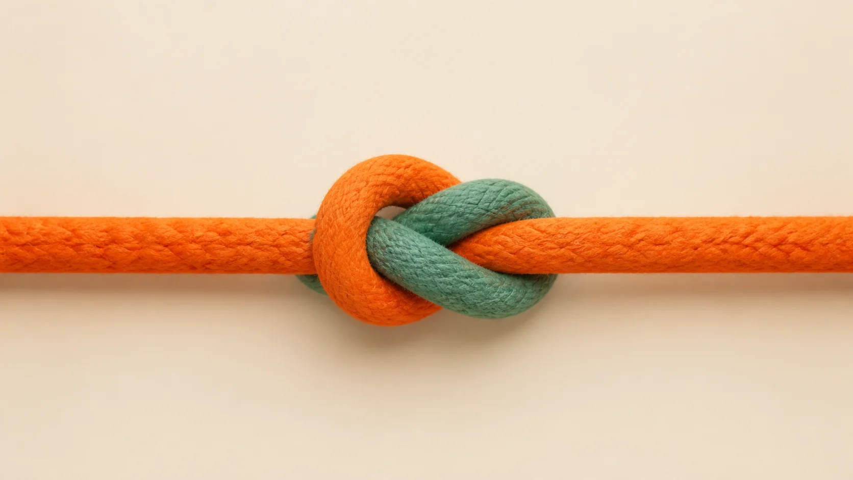Orange and green cords tied together in a central knot